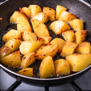 Golden-brown potatoes, seasoned and diced, served as a hearty breakfast side.