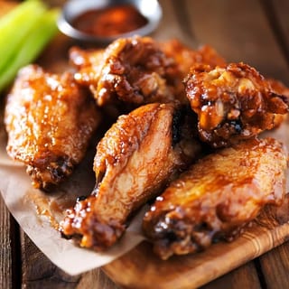 A set of chicken wings, glazed and ready to be enjoyed as part of your party spread
