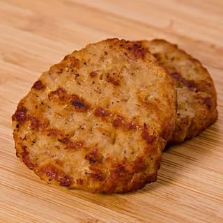 Savory turkey sausage patties, seasoned and grilled to a golden-brown finish.