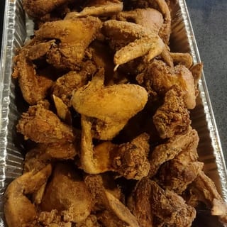 Jumbo-sized chicken wings, seasoned and fried to a golden-brown finish.