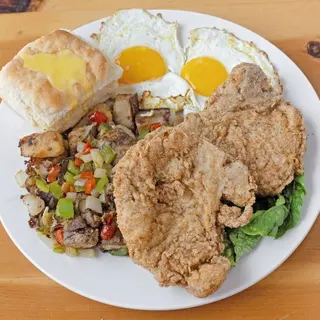 2 pork chops, 2 eggs, toast, and hash or country potatoes.